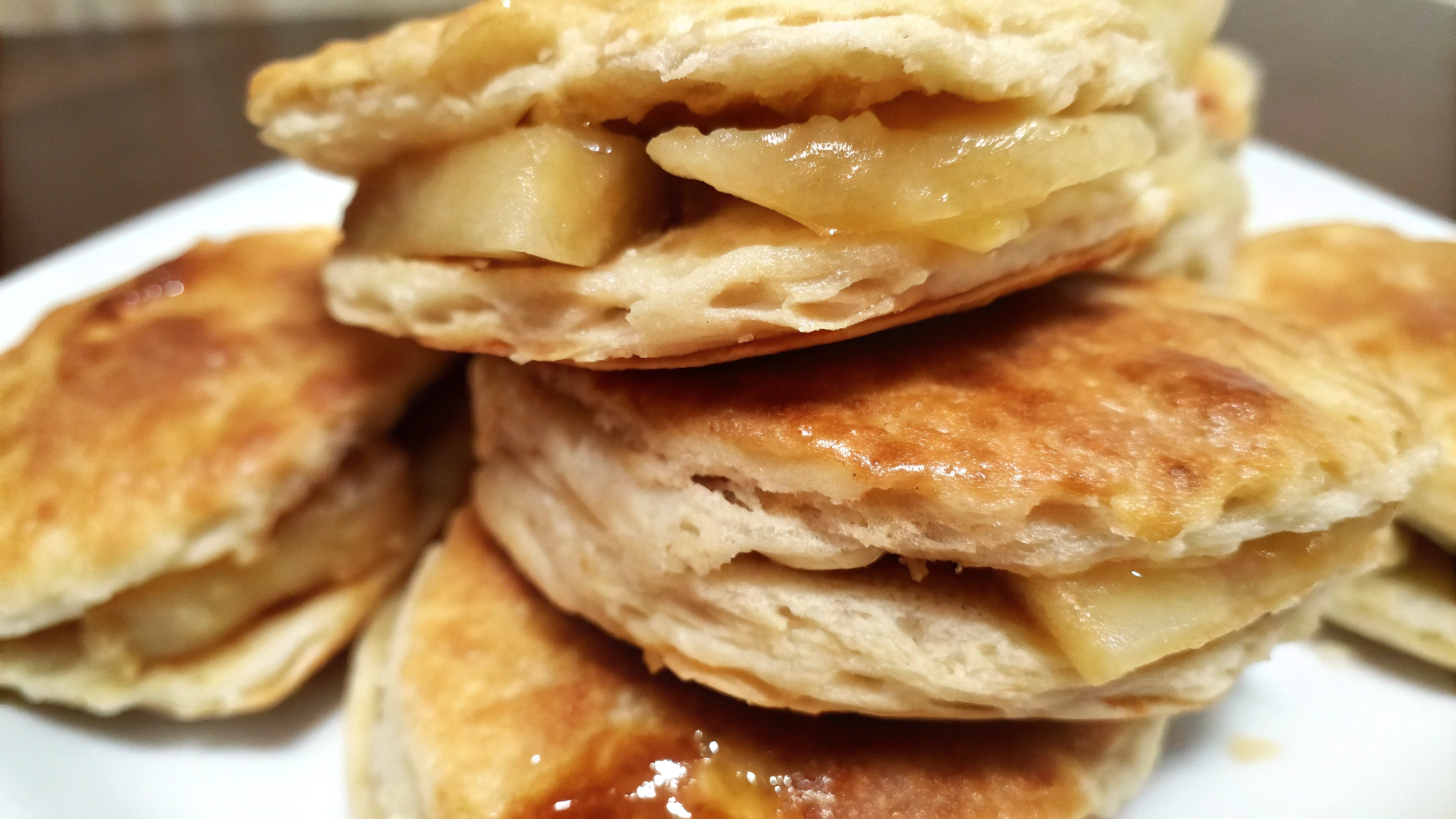 Freshly baked Apple Pie Biscuits with a golden, flaky crust and a hint of cinnamon and apples.